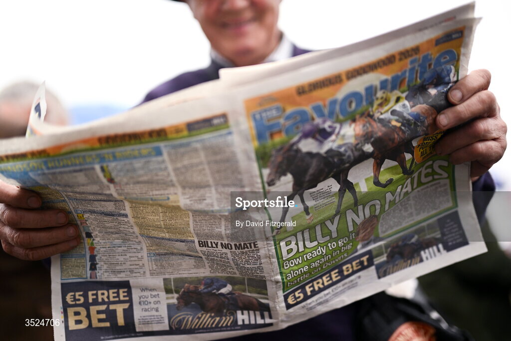 27 July 2026; A racegoer checks the form in the newspaper prior to racing during day one of the Galway Races Summer Festival at Ballybrit Racecourse in Galway. Photo by David Fitzgerald/Sportsfile