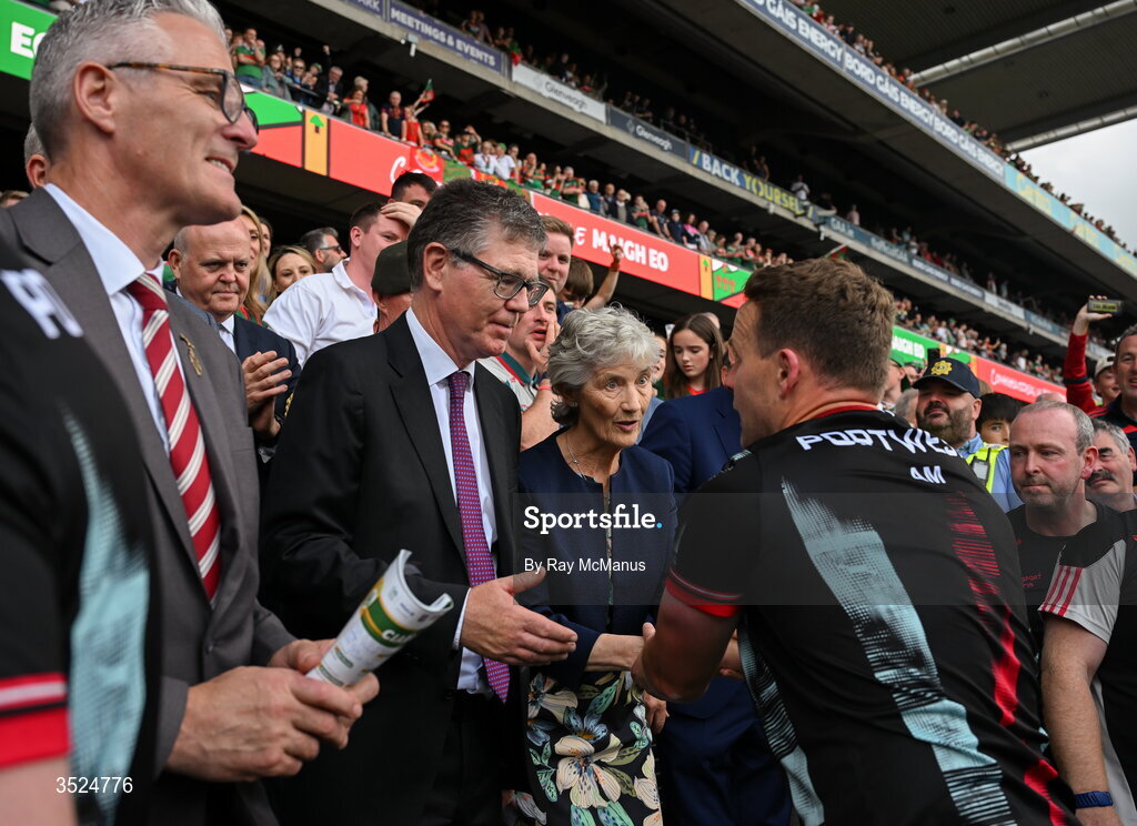 26 July 2026; Uachtarán Chumann Lúthchleas Gael Jarlath Burns and Ard Stiúrthóir of the GAA Tom Ryan look on as Mayo manager Andy Moran is congratulated by Uachtarán na hÉireann Catherine Connolly after the GAA Football All-Ireland Senior Championship final match between Kerry and Mayo at Croke Park in Dublin. Photo by Ray McManus/Sportsfile