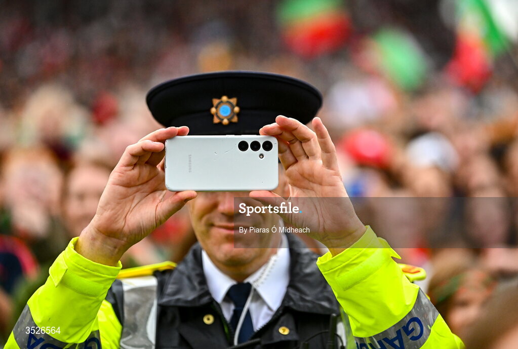 27 July 2026; A member of an Garda Síochána records a video of players on stage during the homecoming celebrations of the All-Ireland Senior Football Champions at Hastings Insurance MacHale Park in Castlebar, Mayo. Photo by Piaras Ó Mídheach/Sportsfile