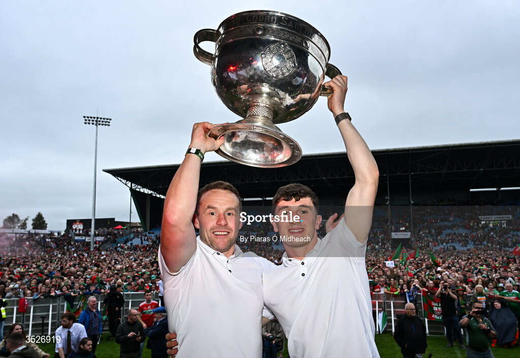 27 July 2026; Mayo manager Andy Moran, left, and Mayo captain Jack Coyne celebrate with the Sam Maguire Cup during the homecoming celebrations of the All-Ireland Senior Football Champions at Hastings Insurance MacHale Park in Castlebar, Mayo. Photo by Piaras Ó Mídheach/Sportsfile