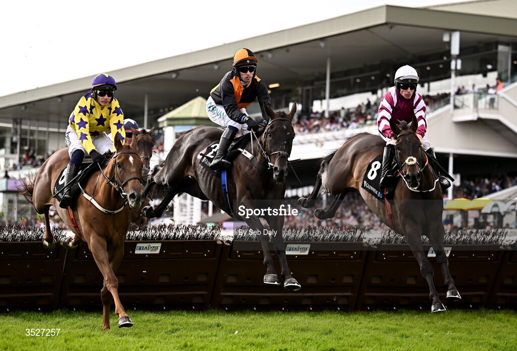 30 July 2026; Midnight Jet, centre, with Darragh O'Keeffe up, clear a hurdle on their way to winning the Guinness Novice Hurdle, from second place Roc Dino, left, with Paul Townend up, during day four of the Galway Races Summer Festival at Ballybrit Racecourse in Galway. Photo by Seb Daly/Sportsfile