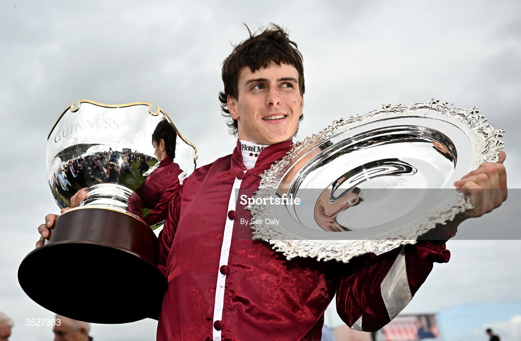 30 July 2026; Jockey Daniel King with the Guinness Galway Hurdle Handicap trophy and Galway Plate trophy after winning the Guinness Galway Hurdle Handicap on Putapoundinthejar during day four of the Galway Races Summer Festival at Ballybrit Racecourse in Galway. Photo by Seb Daly/Sportsfile