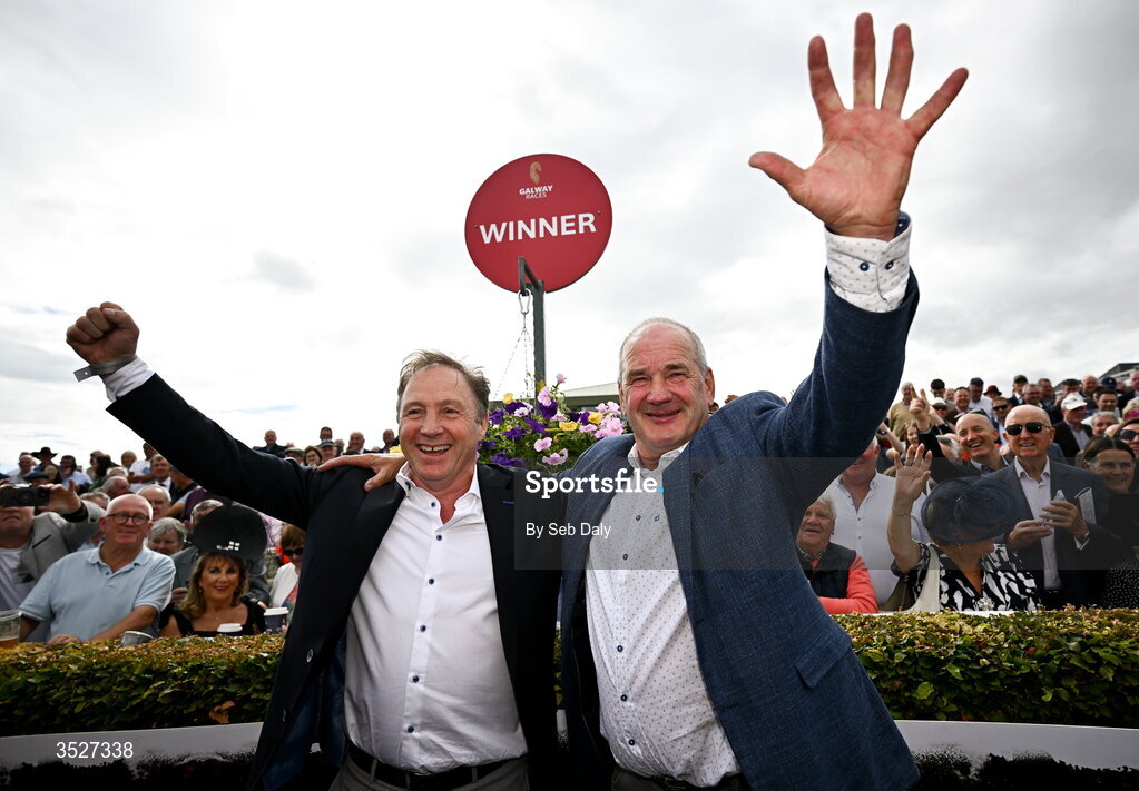 30 July 2026; Trainer Tony Martin, right, and owner Ray Grehan celebrate after sending out Putapoundinthejar to win the Guinness Galway Hurdle Handicap during day four of the Galway Races Summer Festival at Ballybrit Racecourse in Galway. Photo by Seb Daly/Sportsfile