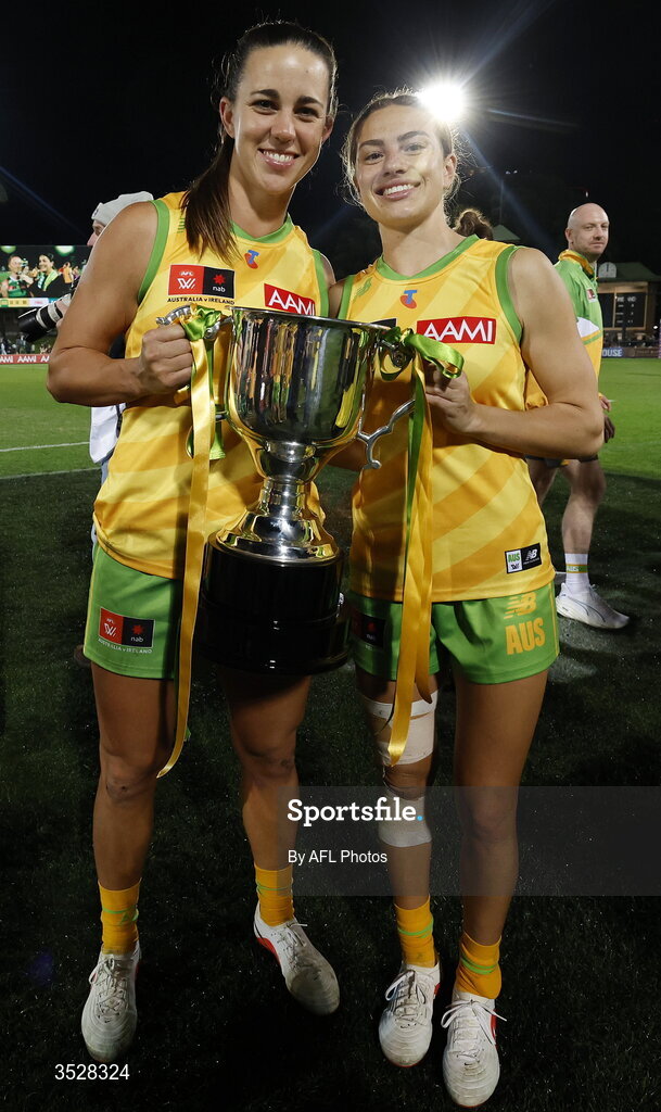 1 August 2026; Australia players Chloe Molloy, left, and Zippy Fish celebrate with the cup after victory in the AFLW test match between Australia and Ireland at the North Sydney Oval in Sydney, Australia. Photo by Darrian Traynor/Getty Images/AFL Photos via Sportsfile