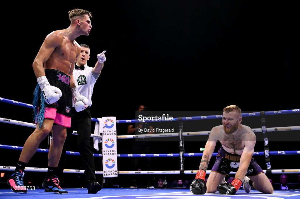 1 August 2026; John Joe Carrigan, left, reacts after knocking down Sean Murray during their super welterweight bout during the Boxing in Dublin event at the 3Arena in Dublin. Photo by David Fitzgerald/Sportsfile