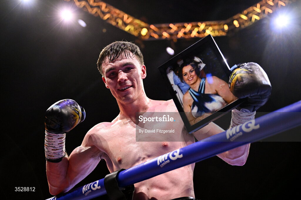 1 August 2026; Bobbi Flood holds up a photograph of his mother Cleevla after being declared victorious over Tariq Davis in their super welterweight bout during the Boxing in Dublin event at the 3Arena in Dublin. Photo by David Fitzgerald/Sportsfile
