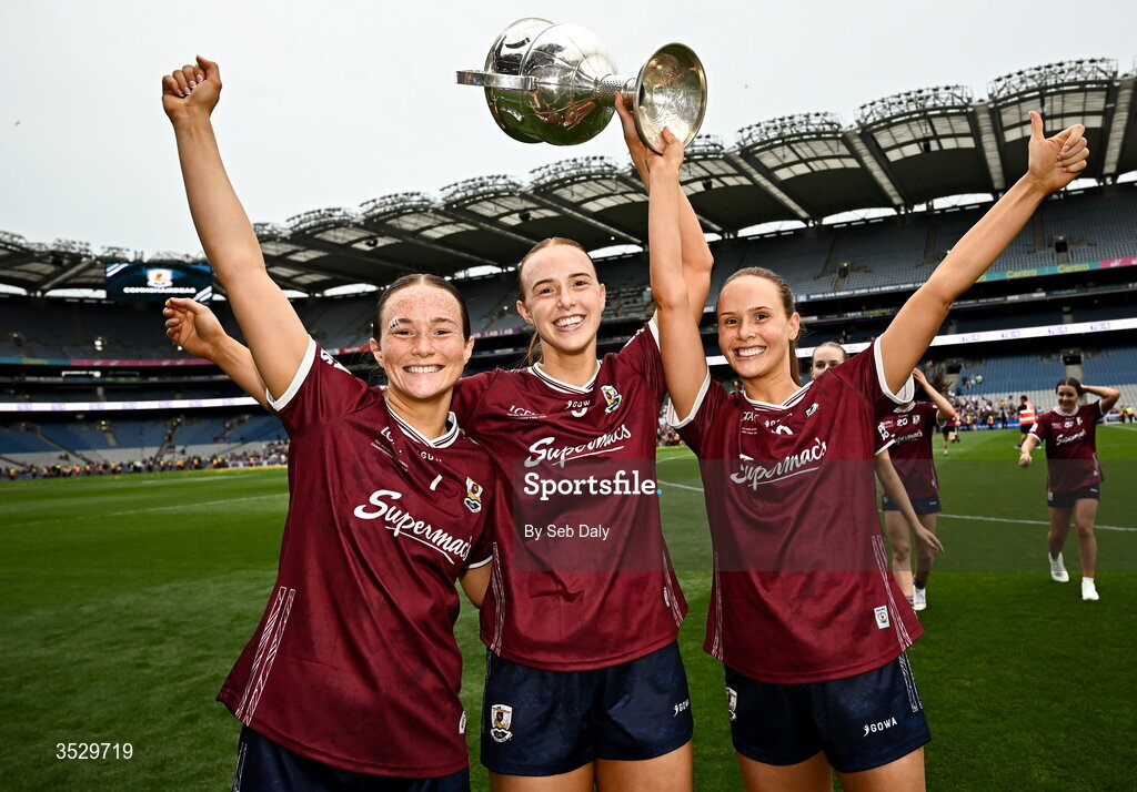 2 August 2026; Galway players, from left, Niamh Divilly, Siobhán Divilly, and Olivia Divilly with the Brendan Martin Cup after the LGFA TG4 All-Ireland Senior Championship final match between Galway and Kerry at Croke Park in Dublin. Photo by Seb Daly/Sportsfile