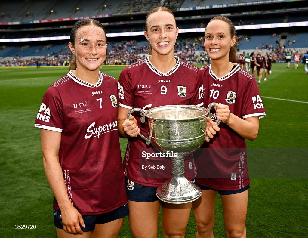 2 August 2026; Galway players, from left, Niamh Divilly, Siobhán Divilly, and Olivia Divilly with the Brendan Martin Cup after the LGFA TG4 All-Ireland Senior Championship final match between Galway and Kerry at Croke Park in Dublin. Photo by Seb Daly/Sportsfile