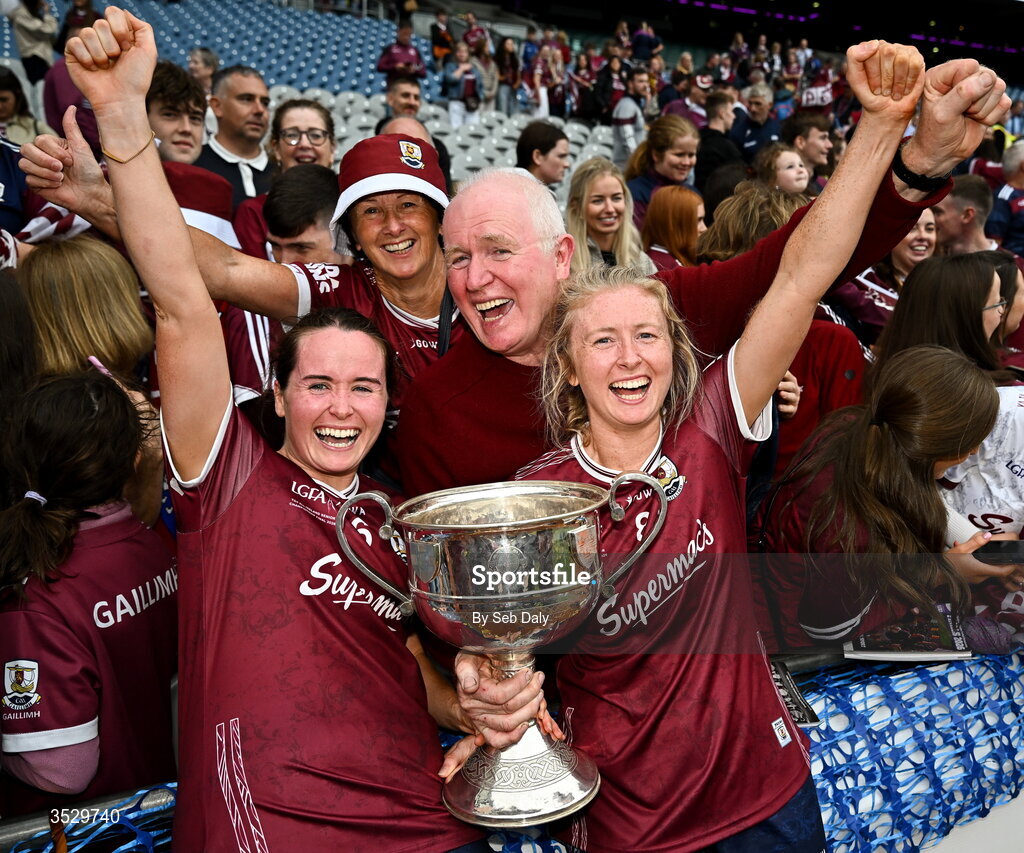 2 August 2026; Galway players Nicola Ward, left, and Louise Ward, celebrate with their parents Chrissie and Willie and the Brendan Martin Cup after the LGFA TG4 All-Ireland Senior Championship final match between Galway and Kerry at Croke Park in Dublin. Photo by Seb Daly/Sportsfile