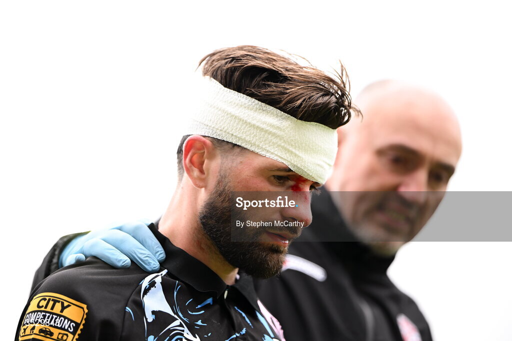 2 August 2026; Brandon Fleming of Derry City leaves the pitch with a head injury accompanied by physiotherapist Colum O'Neill during the SSE Airtricity Men's Premier Division match between St Patrick's Athletic and Derry City at Richmond Park in Dublin. Photo by Stephen McCarthy/Sportsfile