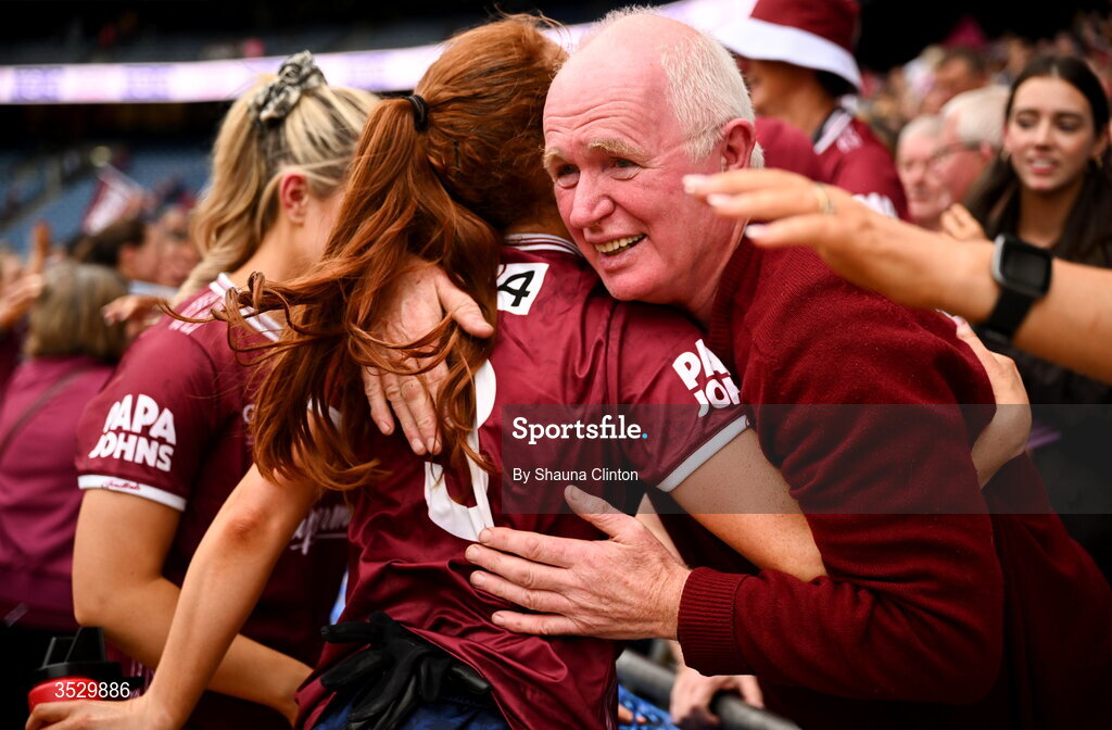 2 August 2026; Sarah Ní Loingsigh of Galway celebrates with Willie Ward, father of teammates Nicole and Louise Ward, after the LGFA TG4 All-Ireland Senior Championship final match between Galway and Kerry at Croke Park in Dublin. Photo by Shauna Clinton/Sportsfile