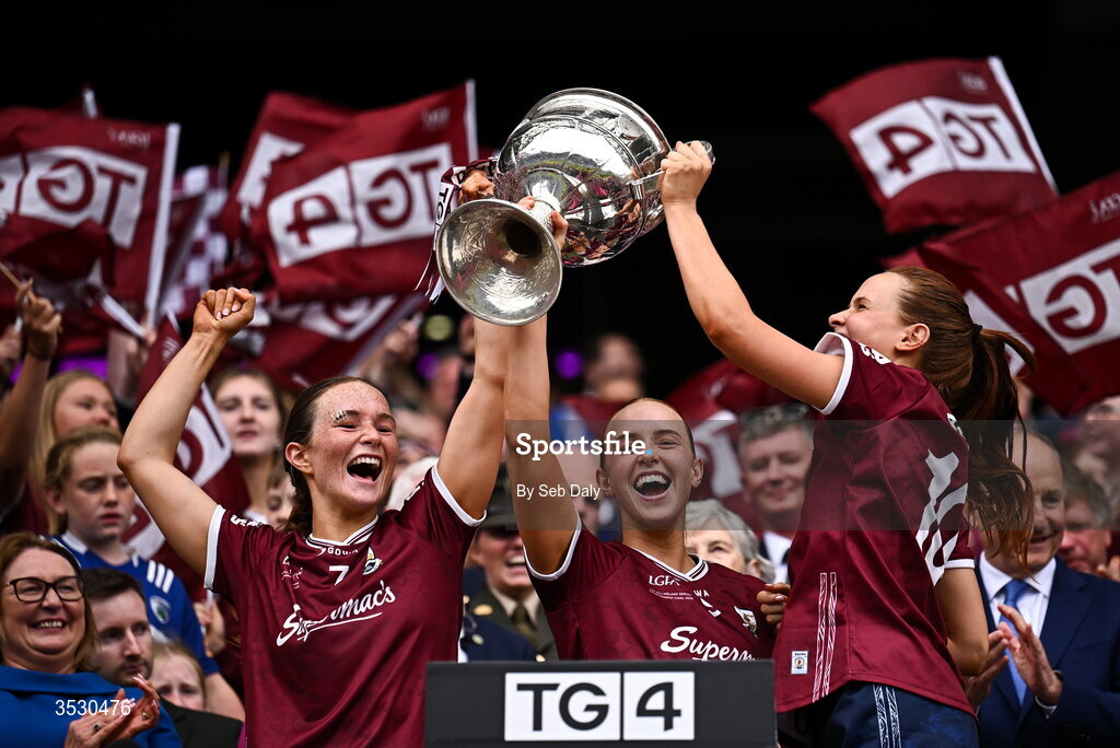 2 August 2026; Galway players, from left, Niamh Divilly, Siobhán Divilly, and Olivia Divilly lift the Brendan Martin Cup following the LGFA TG4 All-Ireland Senior Championship final match between Galway and Kerry at Croke Park in Dublin. Photo by Seb Daly/Sportsfile