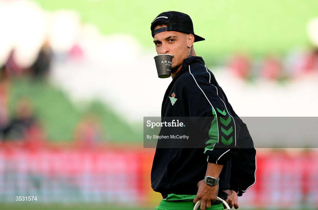 5 August 2026; Antony of Real Betis holds a cup in his mouth while inspecting the pitch before the pre-season friendly match between Arsenal and Real Betis at the Aviva Stadium in Dublin. Photo by Stephen McCarthy/Sportsfile
