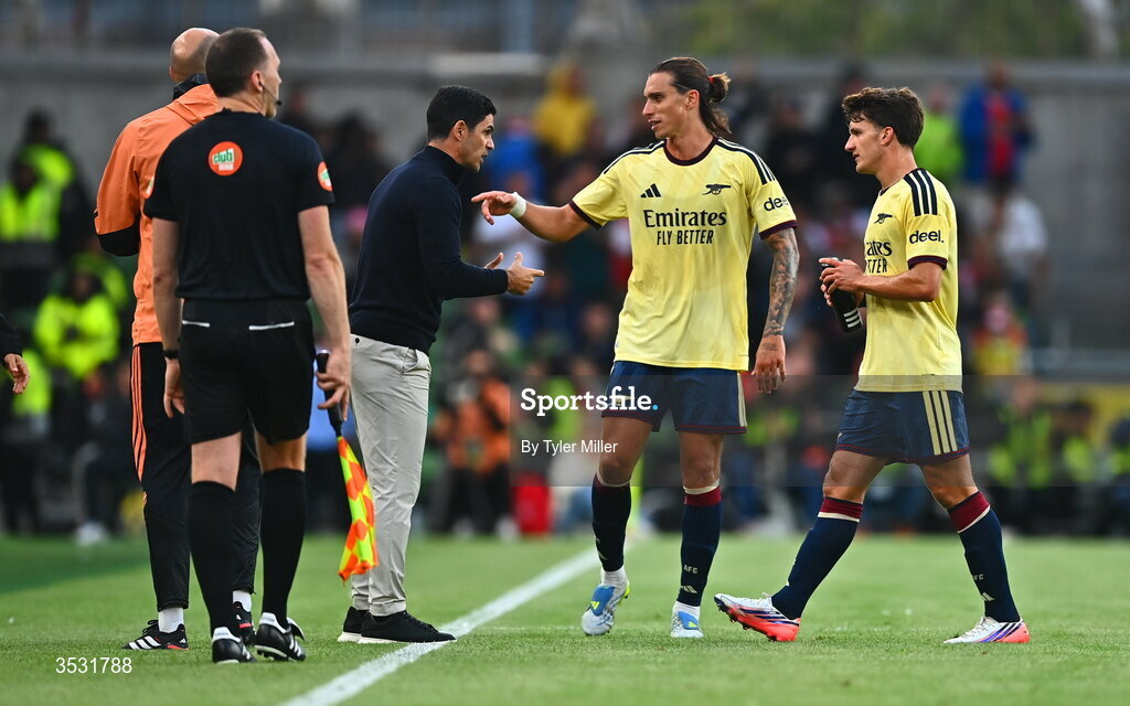 5 August 2026; Arsenal manager Mikel Arteta and Riccardo Calafiori speak during the pre-season friendly match between Arsenal and Real Betis at the Aviva Stadium in Dublin. Photo by Tyler Miller/Sportsfile