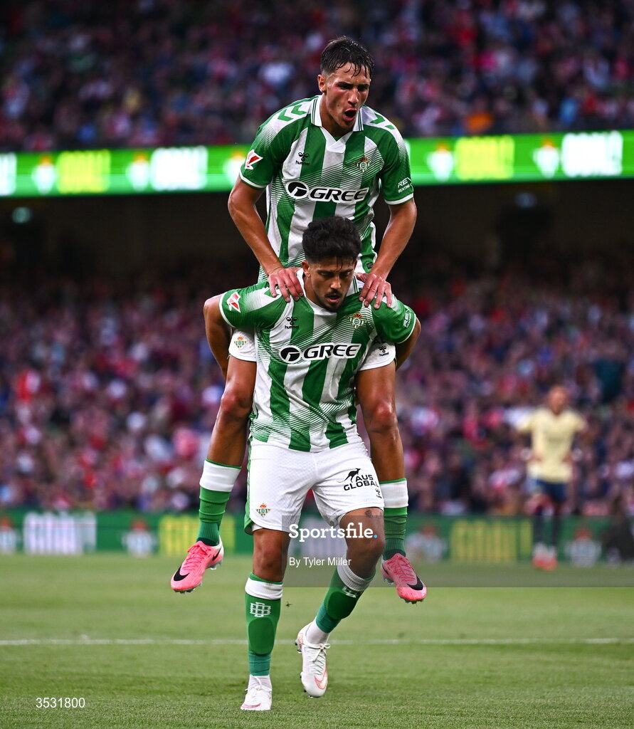 5 August 2026; Pablo Fornals of Real Betis celebrates with Facundo Bernal on his shoulers after scoring his side's third goal during the pre-season friendly match between Arsenal and Real Betis at the Aviva Stadium in Dublin. Photo by Tyler Miller/Sportsfile