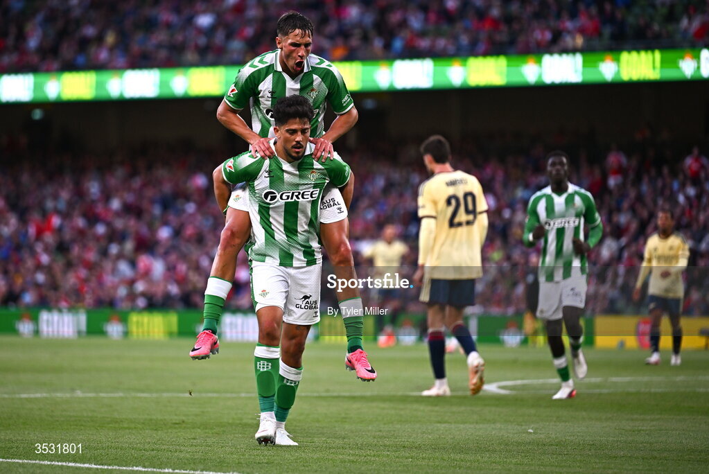 5 August 2026; Pablo Fornals of Real Betis celebrates with Facundo Bernal on his shoulers after scoring his side's third goal during the pre-season friendly match between Arsenal and Real Betis at the Aviva Stadium in Dublin. Photo by Tyler Miller/Sportsfile