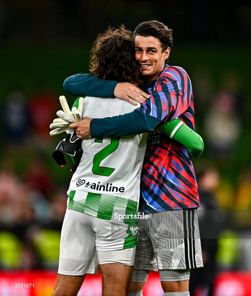 5 August 2026; Arsenal goalkeeper Kepa Arrizabalaga, right hugs Héctor Bellerín of Real Betis after the pre-season friendly match between Arsenal and Real Betis at the Aviva Stadium in Dublin. Photo by Tyler Miller/Sportsfile