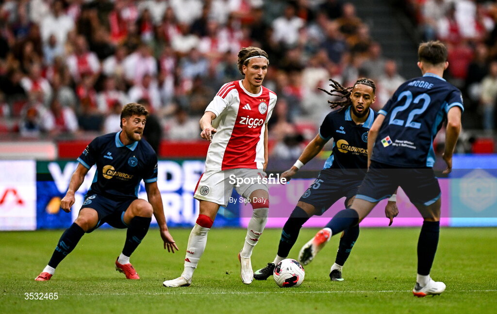 6 August 2026; Mika Godts of Ajax in action against Milan Mbeng of Shelbourne during the UEFA Conference League Third Qualifying Round first leg match between Ajax and Shelbourne at Johan Cruyff Arena in Amsterdam, Netherlands. Photo by Seb Daly/Sportsfile