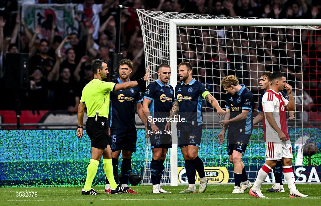 6 August 2026; Shelbourne players protest to referee Atilla Karaoglan after he awarded a penalty during the UEFA Conference League Third Qualifying Round first leg match between Ajax and Shelbourne at Johan Cruyff Arena in Amsterdam, Netherlands. Photo by Seb Daly/Sportsfile