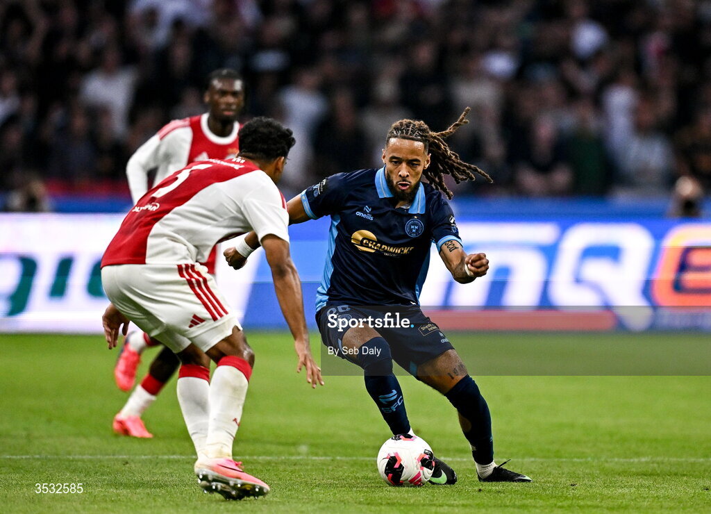 6 August 2026; Milan Mbeng of Shelbourne in action against Owen Wijndal of Ajax during the UEFA Conference League Third Qualifying Round first leg match between Ajax and Shelbourne at Johan Cruyff Arena in Amsterdam, Netherlands. Photo by Seb Daly/Sportsfile