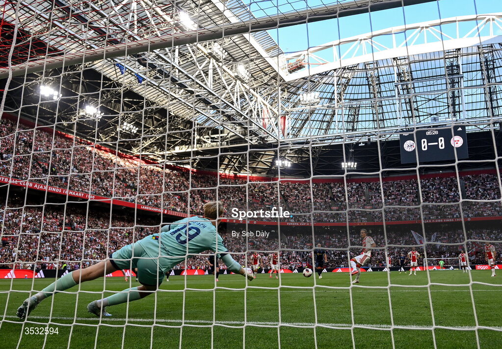 6 August 2026; Mika Godts of Ajax shoots to score his side's first goal, from a penalty, past Shelbourne goalkeeper Eddie Beach during the UEFA Conference League Third Qualifying Round first leg match between Ajax and Shelbourne at Johan Cruyff Arena in Amsterdam, Netherlands. Photo by Seb Daly/Sportsfile