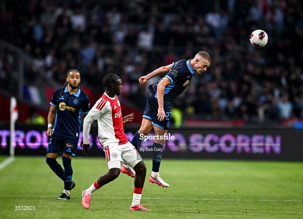 6 August 2026; Evan Caffrey of Shelbourne in action against Jorthy Mokio of Ajax during the UEFA Conference League Third Qualifying Round first leg match between Ajax and Shelbourne at Johan Cruyff Arena in Amsterdam, Netherlands. Photo by Seb Daly/Sportsfile