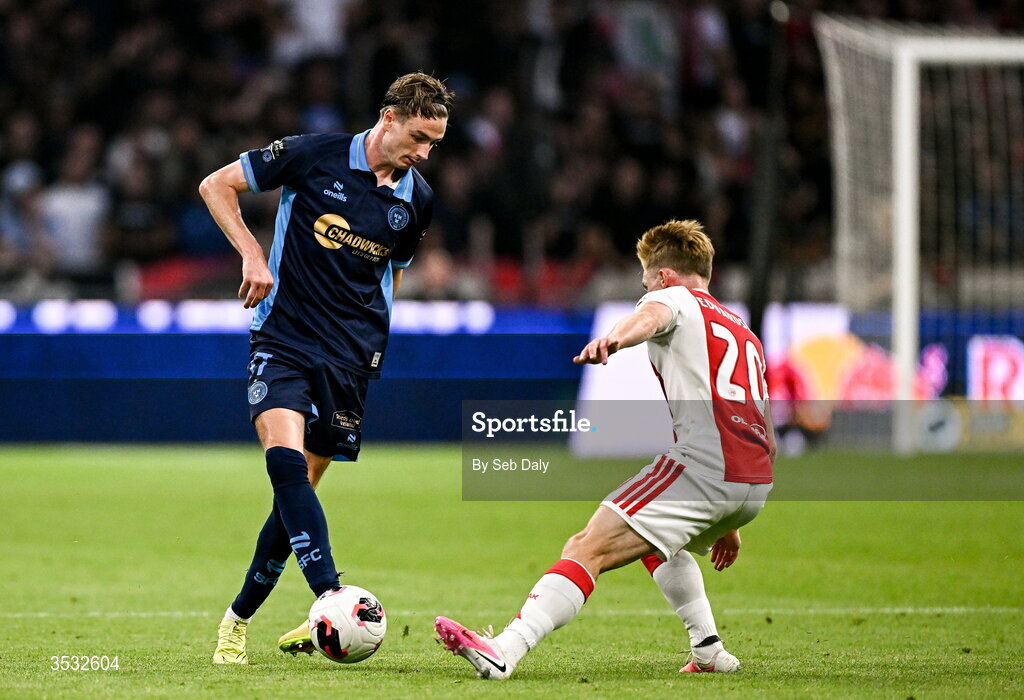 6 August 2026; Daniel Kelly of Shelbourne in action against Oliver Edvardsen of Ajax during the UEFA Conference League Third Qualifying Round first leg match between Ajax and Shelbourne at Johan Cruyff Arena in Amsterdam, Netherlands. Photo by Seb Daly/Sportsfile