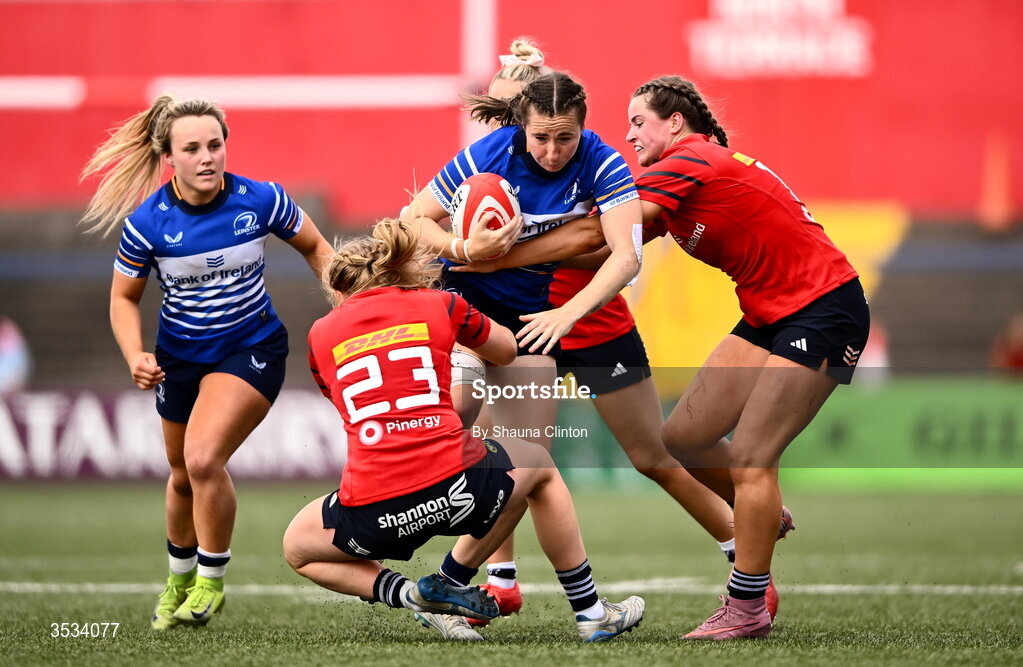 8 August 2026; Eve Higgins of Leinster is tackled by Munster players Ellen Boylan, left, and Katie Corrigan during the Vodafone Womens Interprovincial Championship Round 1 match between Munster and Leinster at Virgin Media Park in Cork. Photo by Shauna Clinton/Sportsfile