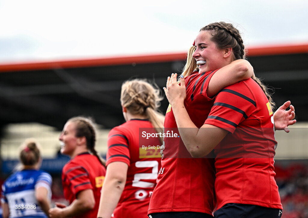 8 August 2026; Katie Corrigan of Munster, right, celebrates with teammate Clodagh O’Halloran after scoring their side's sixth try during the Vodafone Womens Interprovincial Championship Round 1 match between Munster and Leinster at Virgin Media Park in Cork. Photo by Seb Daly/Sportsfile