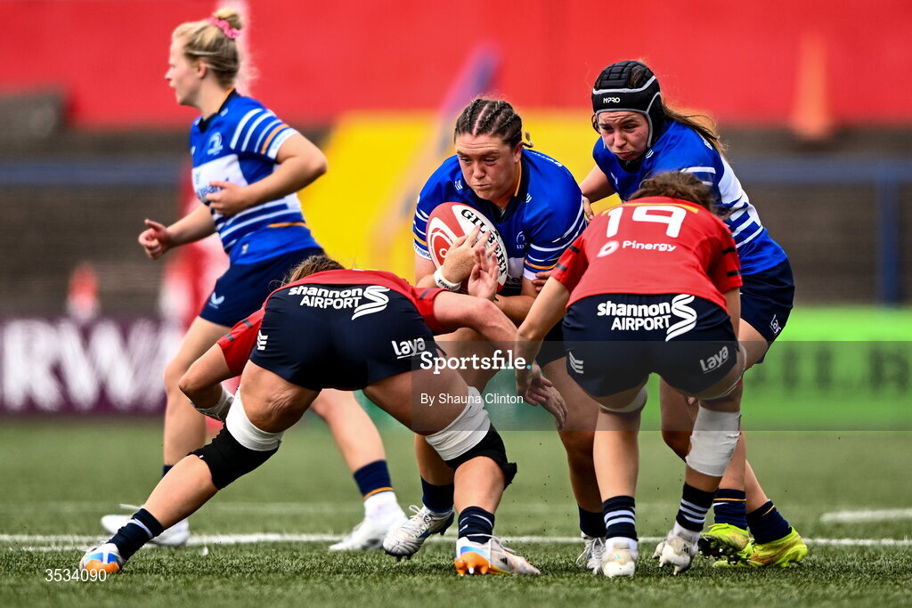 8 August 2026; Hannah Wilson of Leinster is tackled by Munster players Jane Clohessy, left, and Aoibhe O’Flynn during the Vodafone Womens Interprovincial Championship Round 1 match between Munster and Leinster at Virgin Media Park in Cork. Photo by Shauna Clinton/Sportsfile