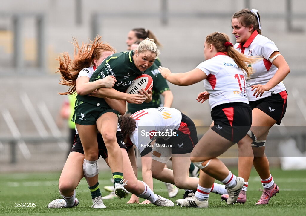 8 August 2026; Alanna Fitzpatrick of Connacht is tackled by Ulster players, from left, Lucy Thompson, Abby Moyles and Sarah Roberts during the Vodafone Womens Interprovincial Championship Round 1 match between Ulster and Connacht at Affidea Stadium in Belfast. Photo by Ben McShane/Sportsfile