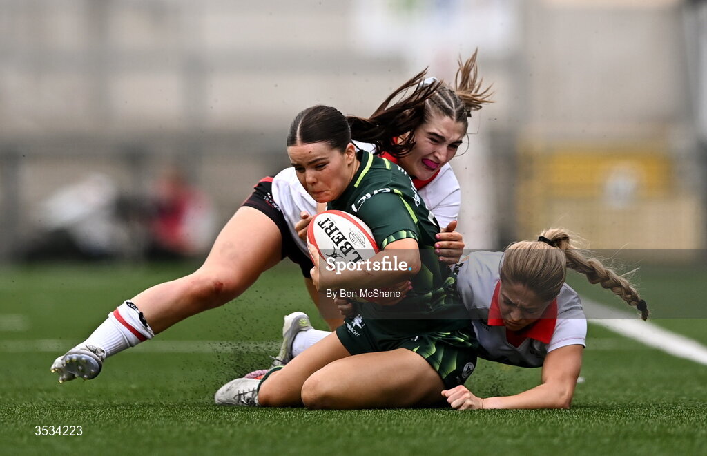 8 August 2026; Emily Foley of Connacht is tackled by Caitlin Crowe, left, and Katie Gilmour of Ulster during the Vodafone Womens Interprovincial Championship Round 1 match between Ulster and Connacht at Affidea Stadium in Belfast. Photo by Ben McShane/Sportsfile