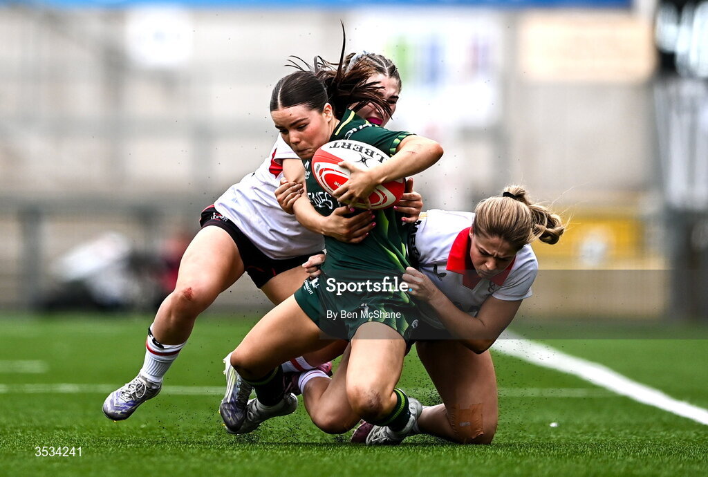 8 August 2026; Emily Foley of Connacht is tackled by Caitlin Crowe, left, and Katie Gilmour of Ulster during the Vodafone Womens Interprovincial Championship Round 1 match between Ulster and Connacht at Affidea Stadium in Belfast. Photo by Ben McShane/Sportsfile