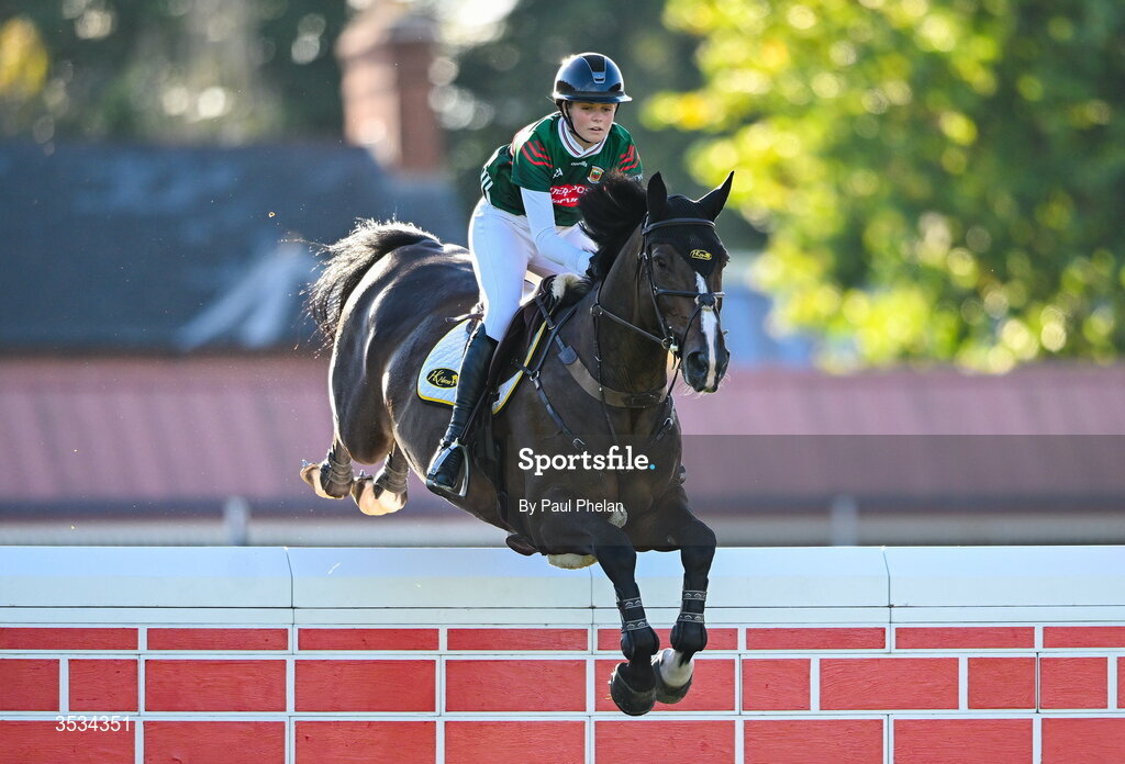 8 August 2026; Rachel Proudley of Great Britain competes on Easy Boy de Laubry Z, wearing a Mayo jersey, in the Defender Puissance during day four of the Gallagher Dublin Horse Show at the RDS in Dublin. Photo by Paul Phelan/Sportsfile
