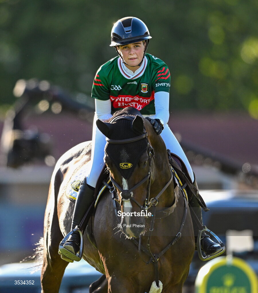 8 August 2026; Rachel Proudley of Great Britain competes on Easy Boy de Laubry Z, wearing a Mayo jersey, in the Defender Puissance during day four of the Gallagher Dublin Horse Show at the RDS in Dublin. Photo by Paul Phelan/Sportsfile