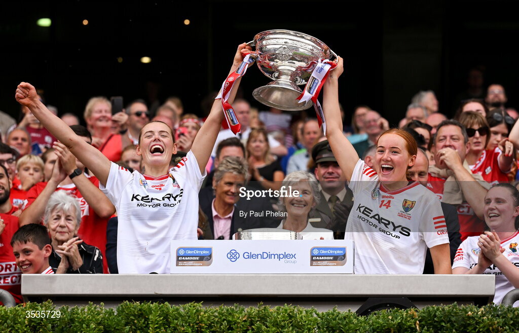 9 August 2026; Sisters Méabh and Orlaith Cahalane of Cork lift the O'Duffy Cup after their side's victory in the Glen Dimplex All-Ireland Senior Camogie Championship final match between Galway and Cork at Croke Park in Dublin. Photo by Paul Phelan/Sportsfile