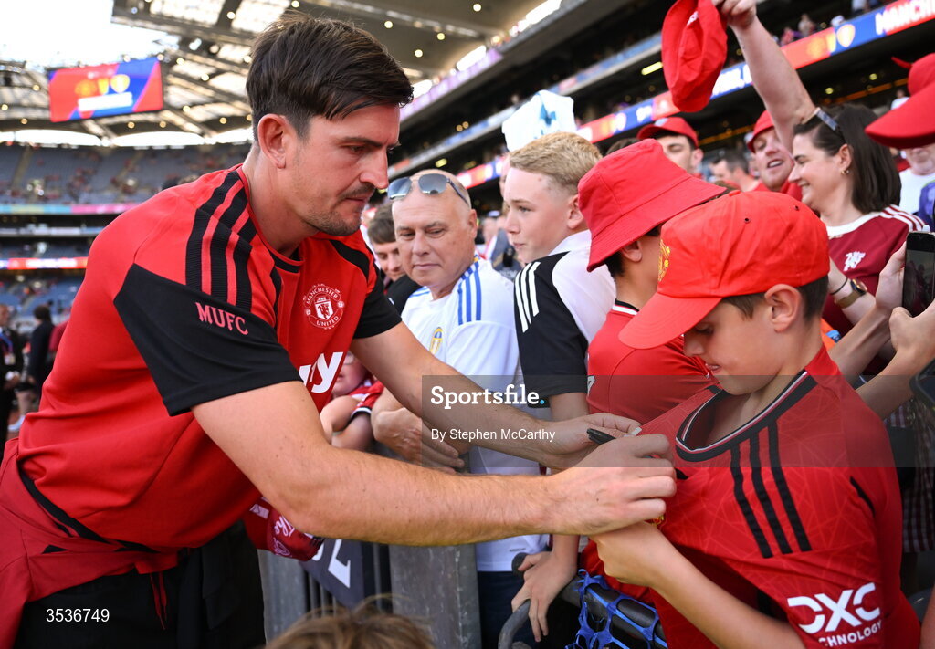 12 August 2026; Harry Maguire of Manchester United signs the jersey of a Manchester United supporter before the pre-season friendly match between Manchester United and Leeds United at Croke Park in Dublin. Photo by Stephen McCarthy/Sportsfile