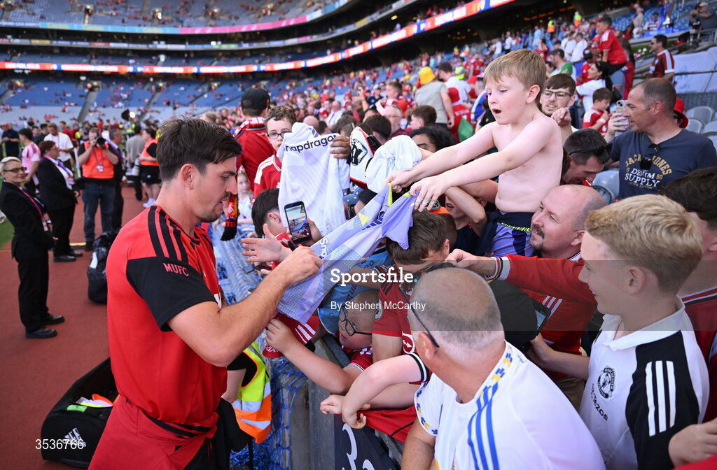 12 August 2026; Harry Maguire of Manchester United signs the jersey of a Manchester United supporter before the pre-season friendly match between Manchester United and Leeds United at Croke Park in Dublin. Photo by Stephen McCarthy/Sportsfile