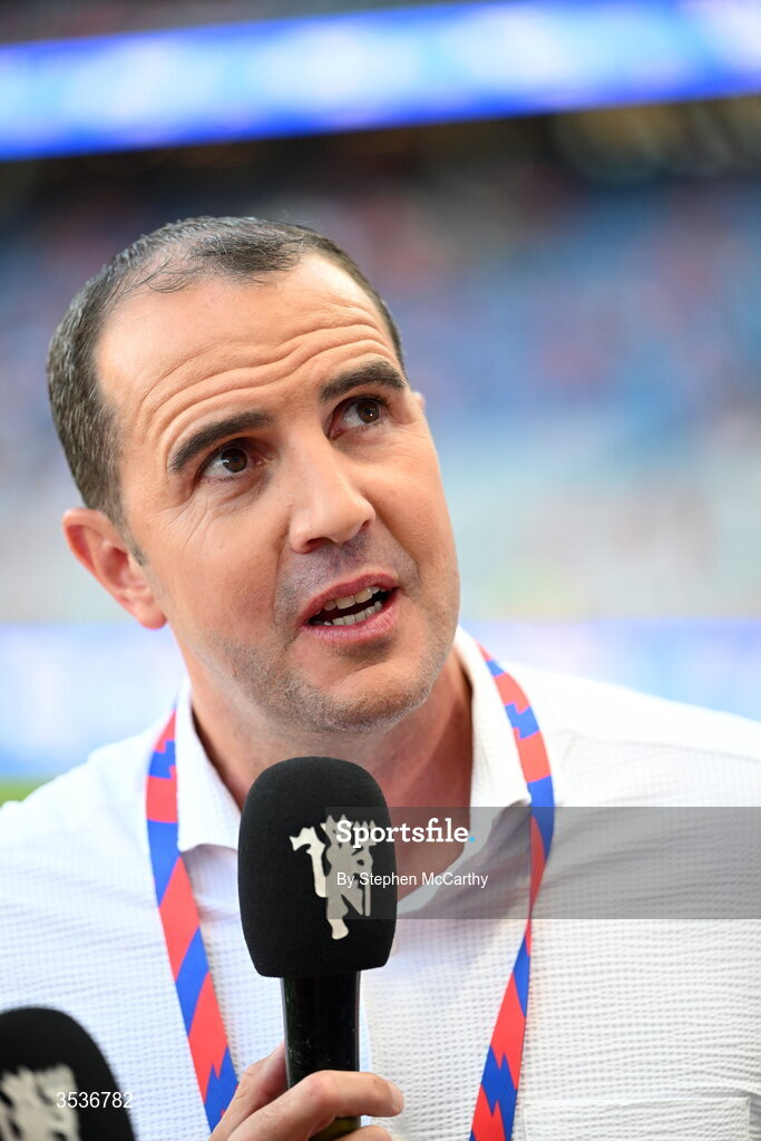 12 August 2026; Republic of Ireland assistant coach and former Manchester United player John O'Shea is interviewed before the pre-season friendly match between Manchester United and Leeds United at Croke Park in Dublin. Photo by Stephen McCarthy/Sportsfile