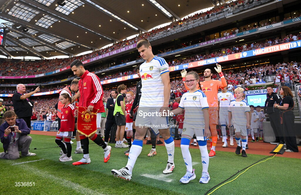 12 August 2026; Captains Jaka Bijol of Leeds United and Diogo Dalot of Manchester United lead out their teams before the pre-season friendly match between Manchester United and Leeds United at Croke Park in Dublin. Photo by Stephen McCarthy/Sportsfile