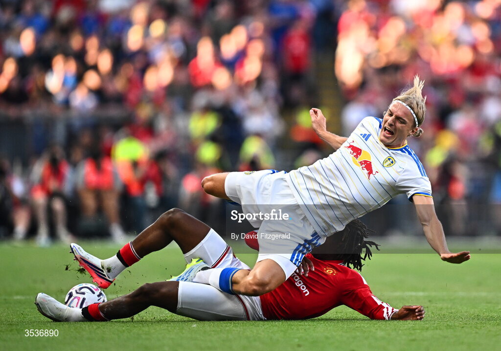 12 August 2026; Sabastiaan Bornauw of Leeds United is tackled by Patrick Dorgu of Manchester United during the pre-season friendly match between Manchester United and Leeds United at Croke Park in Dublin. Photo by David Fitzgerald/Sportsfile