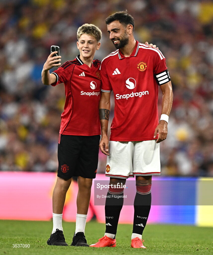 12 August 2026; A pitch invader takes a selfie with Bruno Fernandes of Manchester United during the pre-season friendly match between Manchester United and Leeds United at Croke Park in Dublin. Photo by David Fitzgerald/Sportsfile