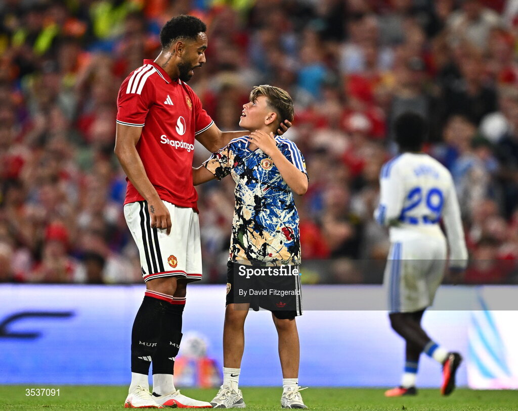 12 August 2026; Matheus Cunha of Manchester United with a pitch invader during the pre-season friendly match between Manchester United and Leeds United at Croke Park in Dublin. Photo by David Fitzgerald/Sportsfile