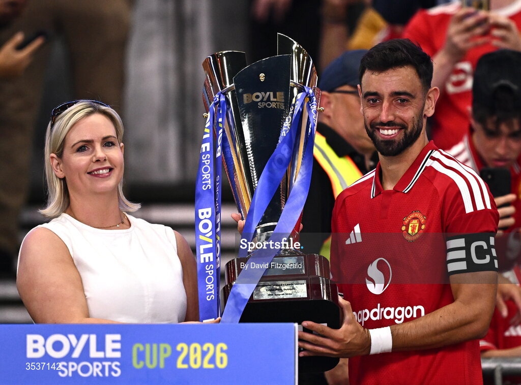 12 August 2026; Manchester United captain Bruno Fernandes is presented with the BOYLE Sports Cup, by Jenna Boyle, President of BOYLE Sports, after the pre-season friendly match between Manchester United and Leeds United at Croke Park in Dublin. Photo by David Fitzgerald/Sportsfile