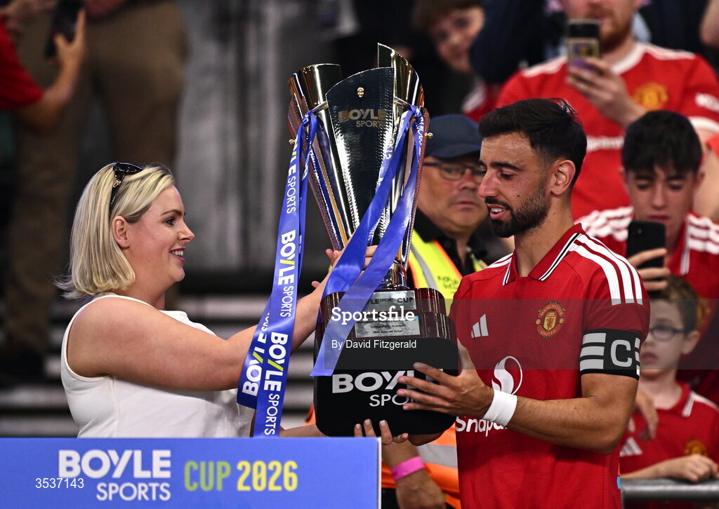 12 August 2026; Manchester United captain Bruno Fernandes is presented with the BOYLE Sports Cup, by Jenna Boyle, President of BOYLE Sports, after the pre-season friendly match between Manchester United and Leeds United at Croke Park in Dublin. Photo by David Fitzgerald/Sportsfile