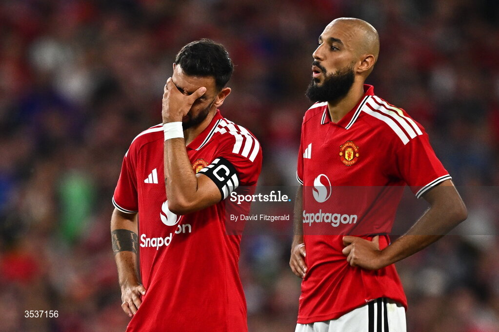 12 August 2026; Bruno Fernandes, left, and Noussair Mazraoui of Manchester United react during the penalty shootout in the pre-season friendly match between Manchester United and Leeds United at Croke Park in Dublin. Photo by David Fitzgerald/Sportsfile
