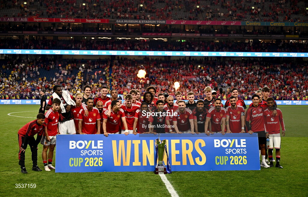 12 August 2026; Manchester United players pose for a photo with the trophy after the pre-season friendly match between Manchester United and Leeds United at Croke Park in Dublin. Photo by Ben McShane/Sportsfile