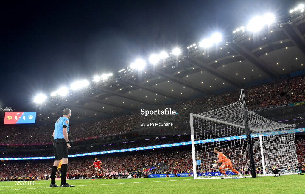 12 August 2026; Noussair Mazraoui of Manchester United shoots to score his side's winning penalty in the penalty shootout during the pre-season friendly match between Manchester United and Leeds United at Croke Park in Dublin. Photo by Ben McShane/Sportsfile