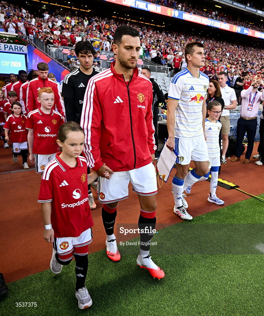 12 August 2026; Diogo Dalot of Manchester United walks out with a mascot before the pre-season friendly match between Manchester United and Leeds United at Croke Park in Dublin. Photo by David Fitzgerald/Sportsfile