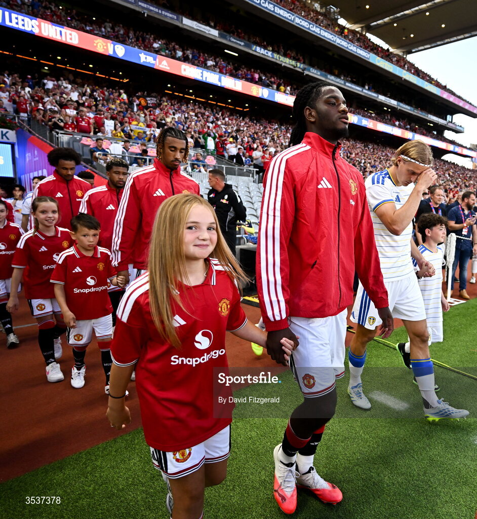 12 August 2026; Ayden Heaven of Manchester United walks out with a mascot before the pre-season friendly match between Manchester United and Leeds United at Croke Park in Dublin. Photo by David Fitzgerald/Sportsfile